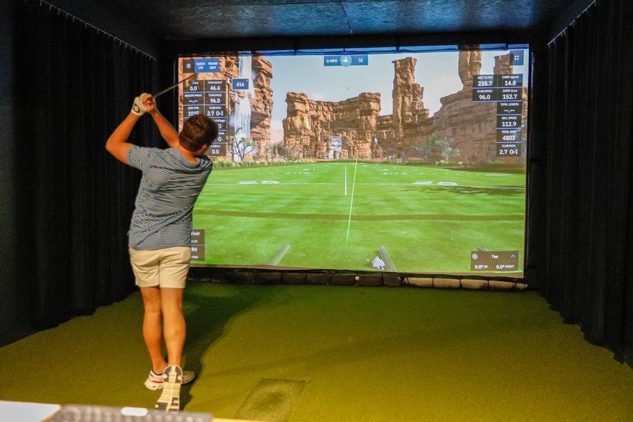 Golfer following through on a simulator shot