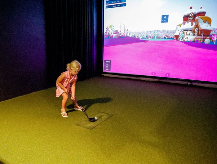 Young girl putting on the simulator